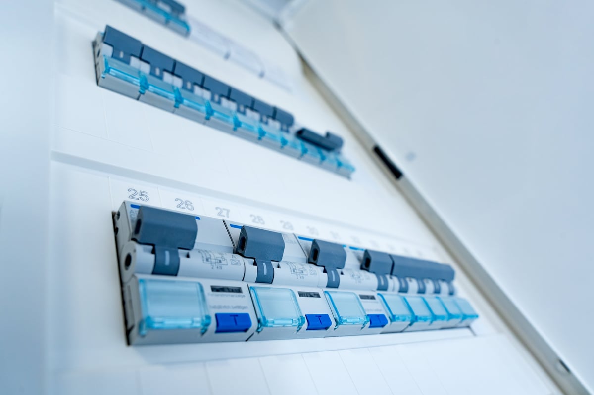 Close-up of residential electrical panel with automatic circuit breakers — whole-home surge protection by Dylco Electric